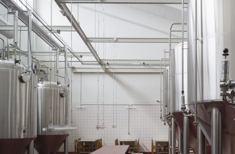 . Paired with simple furniture, the stripped-down, 935-sq-m industrial environment lays a blank canvas. - Hampus Berndtson