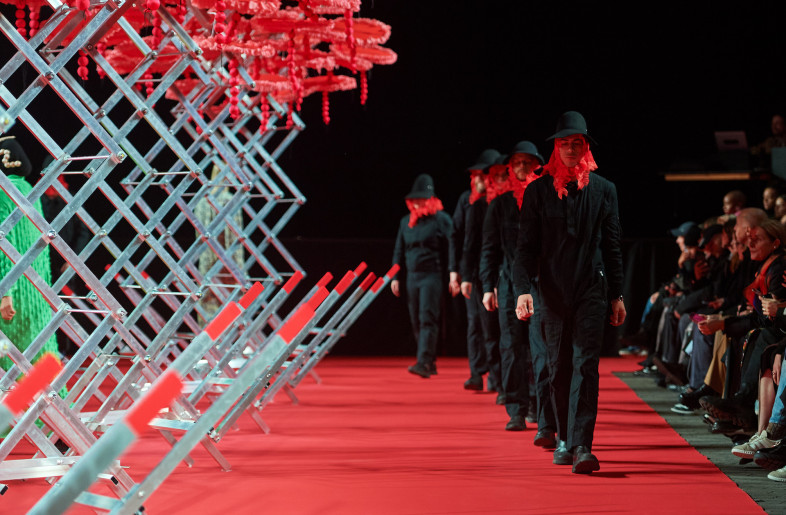 Models strutted down a tomato-red carpet runway. - James Cochrane