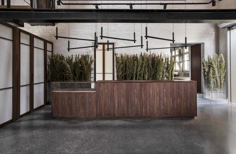 The custom counter, cabinets, and fitting rooms are all carved from walnut and lined with linen. - Sarah Wijzenbeek