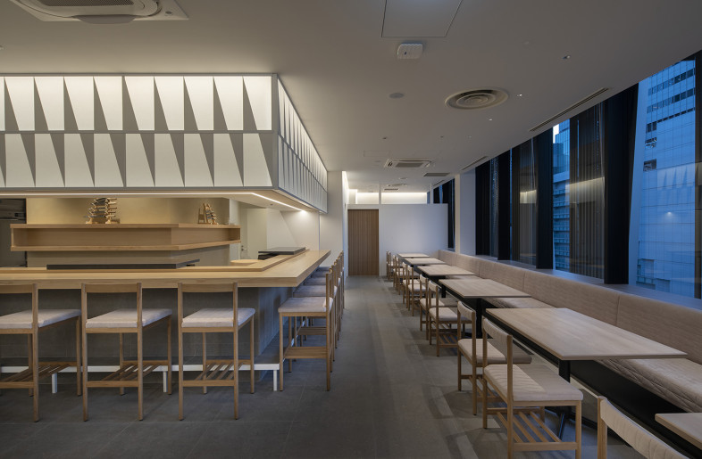 Window-side is the dining area with a view and a long quilted bench seat - Keishiro Yamada