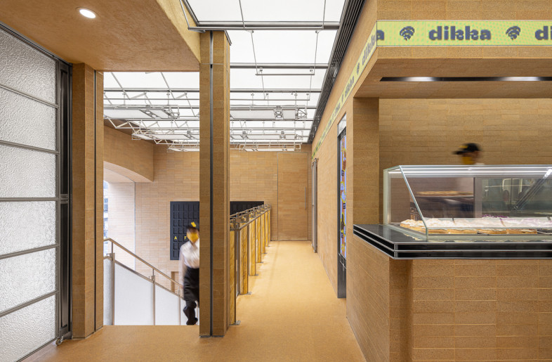 A staircase leads to a second point of sale upstairs where an additional baked goods display is found. - SFAP