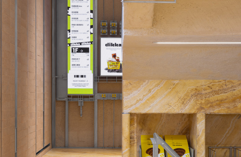 Stone is used for the till counter while glass display cases of baked goods are set on stainless-steel surfaces. - SFAP