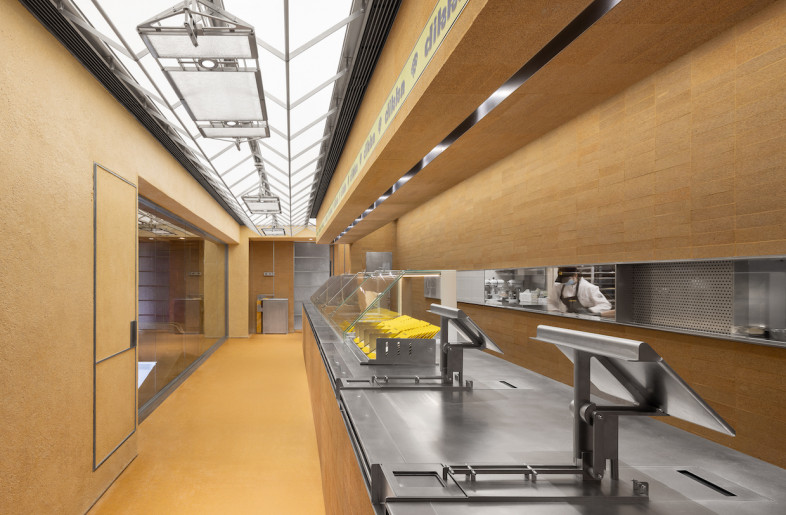 Frosted textured glass and stainless steel piping and perforated metal surface walls are contrasted with smooth brown bricks. - SFAP