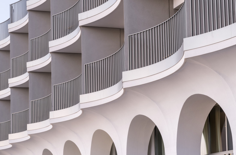 The new façade’s subtly curved form is inspired by the gentle waves of Mirabello Bay and provides a striking new image for the hotel. The plaster finish is typical of local buildings and, applied to the contemporary form, helps root the building in its site. - Rasmus Hjortshøj