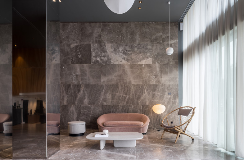 Lobby interior. A palette of natural materials reflective of the surrounding landscape caries the concept through to the interiors - Rasmus Hjortshøj