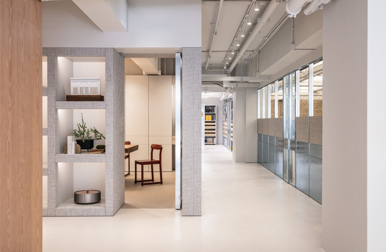 A corridor separates solo work stations from other functional spaces, including a meeting room and the material library. - Kenneth Chao