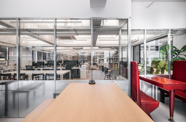 The open-planned space incorporates group discussion tables and different seating options to facilitate different work styles and collaborative efforts. - Kenneth Chao
