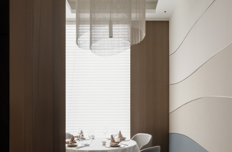 a fishnet light fixture inside the private dining cabin - Wen Studio