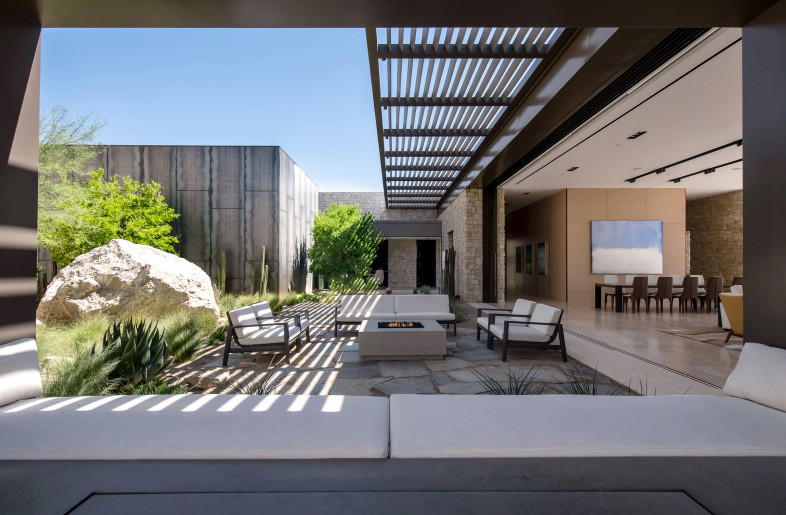 A massive wall of glass, fully concealed within the walls when open, extends the living space into the central courtyard. - Stephen Morgan
