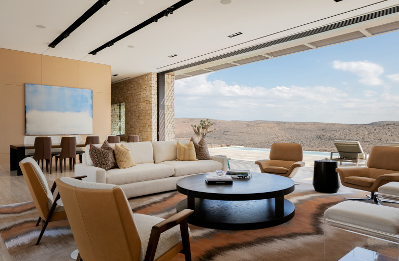 The great room opens to the pool deck with views and breezes from the south. The pool provides evaporative cooling of the interior space and courtyard. - Stetson Ybarra