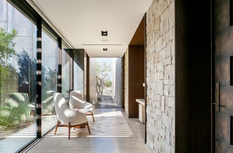 The office is tucked into a wood clad alcove with seating in the circulation corridor to maximize space utilization. - Stetson Ybarra