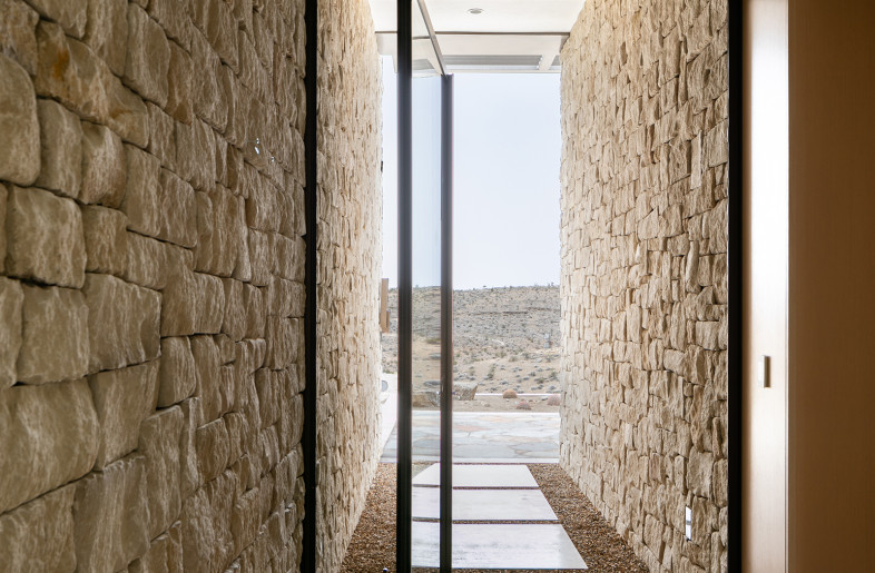 Pivot door leading to the pool deck. - Stetson Ybarra