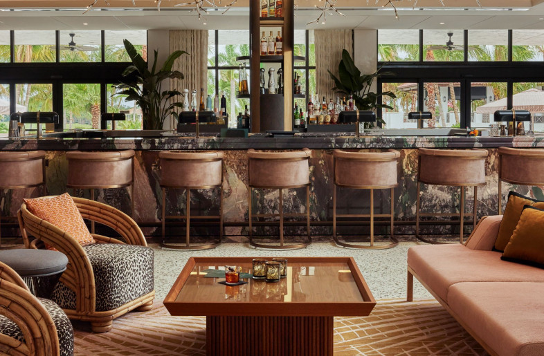 A central floating bar, the lobby’s focal point, sits against the windowed backdrop of silhouetted palm trees and boasts a monolithic bar and a larger-than-life, glimmering interpretation of the city’s beloved Banyan tree handmade from glass and twisted metal. - Mike Schwartz