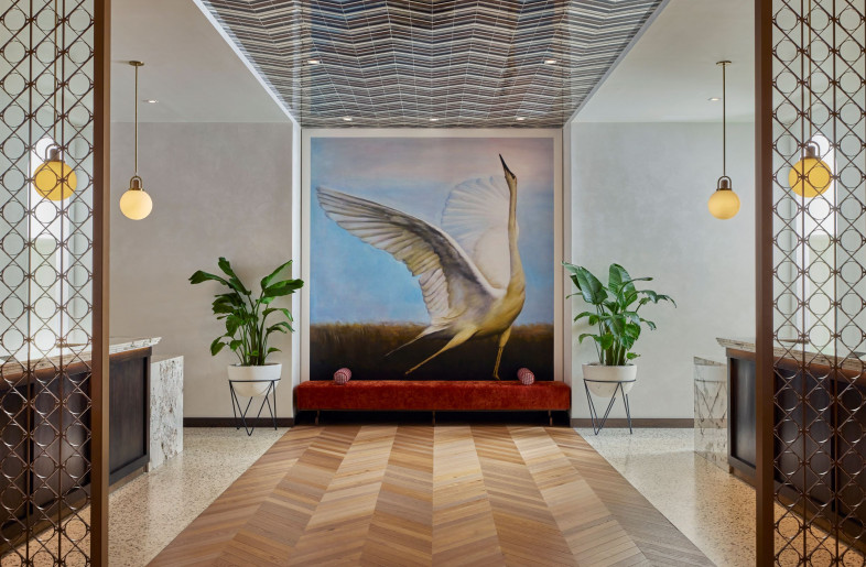 The check-in desk features a floor to ceiling custom art pieces of a swan. - Mike Schwartz