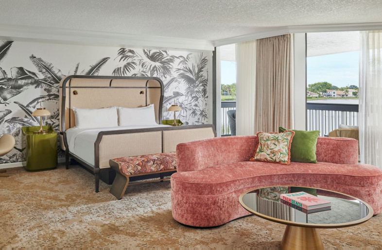 Custom, vintage-inspired wallcoverings, plush area rugs, thickly upholstered headboards complete with moody bedside lighting, mid-century style soft seating, and lacquered and caned case goods are artfully arranged in a way that establishes a calm, collected look. - Mike Schwartz