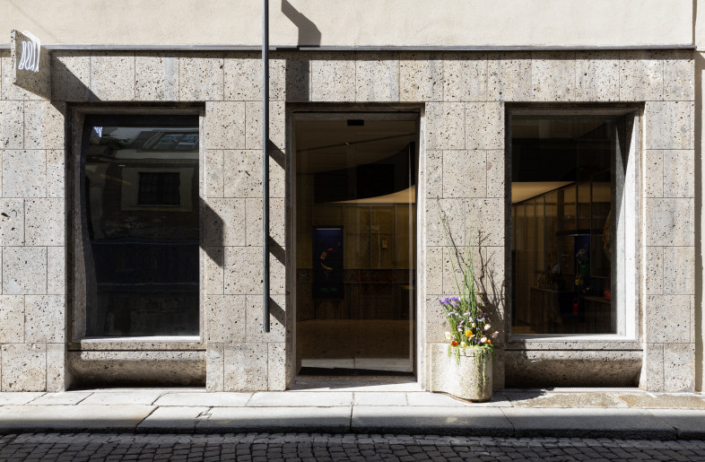outside, a curved mirror which alters the form of the passerby, and a façade-fixed bronze sculpture - BOYY
