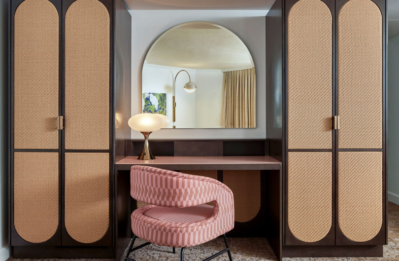 Enjoy getting ready at the vanity in the middle of two 60’s inspired rattan wardrobes. - Mike Schwartz