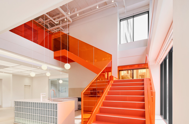 The color of the staircase connects the community's functionality naturally. - studio tom