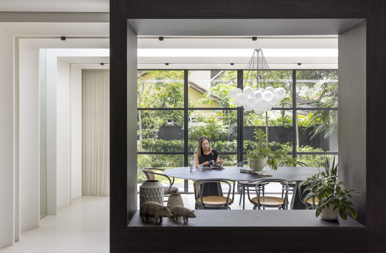 Divider — perfectly frames and separates the dining room and the gardens from the living space while also functioning as a storage space - Triston Yeo