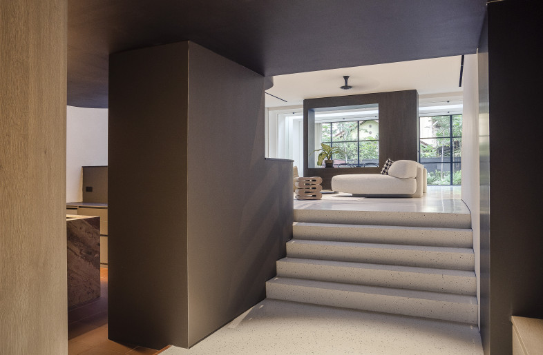 Entrance — intentionally darkened to create a theatrical light-to-dark experience as it leads into the light-filled living spaces. - Triston Yeo