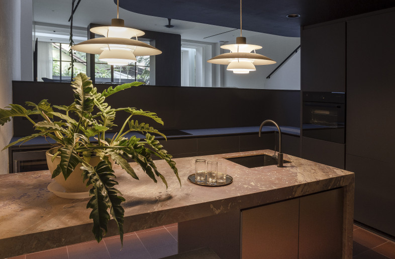 Sunken Dry Kitchen — Located beneath the mezzanine. The materiality of the space blends in harmoniously with the rest of the house’s palette, with the brick tone delicately concealed. - Triston Yeo