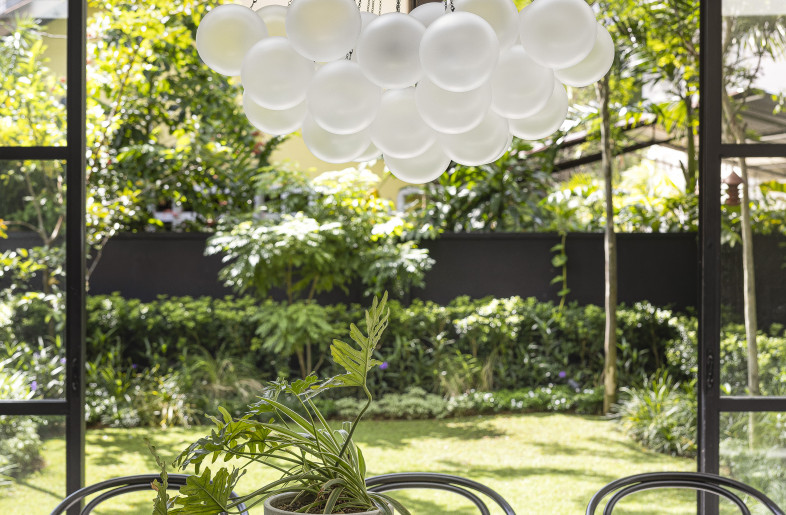 A wall-to-wall framed glass view creates a seamless experience of the gardens, bringing outdoor living indoors. - Triston Yeo