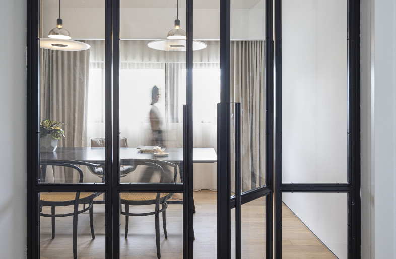 The existing black metal pipework staircase railing design inspired the design of bespoke bathroom accessories as well as glass door dividers, another dialogue between old and new. - Triston Yeo