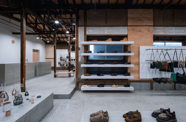 White shelves were mounted to the wall and contrasted with the existing visible wood walls and dormers. - Toha