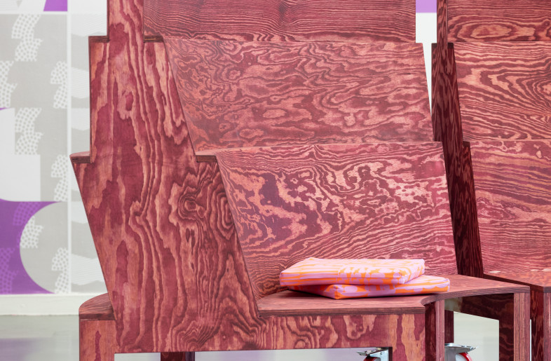 The conventional forms of tables and chairs are stretched and warped, and their timber materiality is enhanced using psychedelic colours. - Titia Hahne