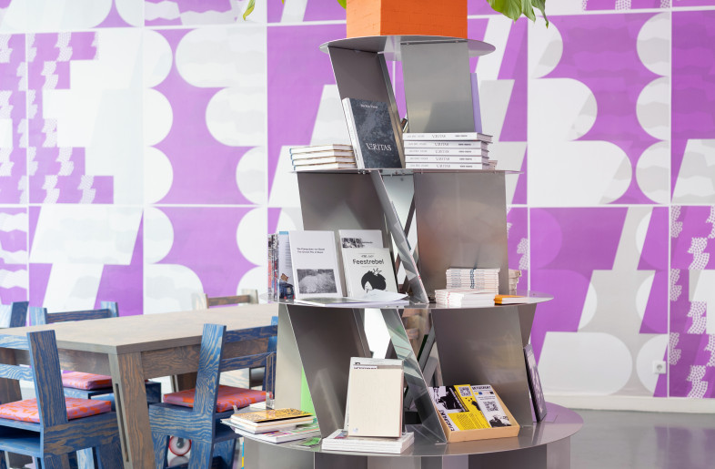 Metallic shelving reminiscent of cage crinolines takes advantage of the height the space has to offer. - Titia Hahne