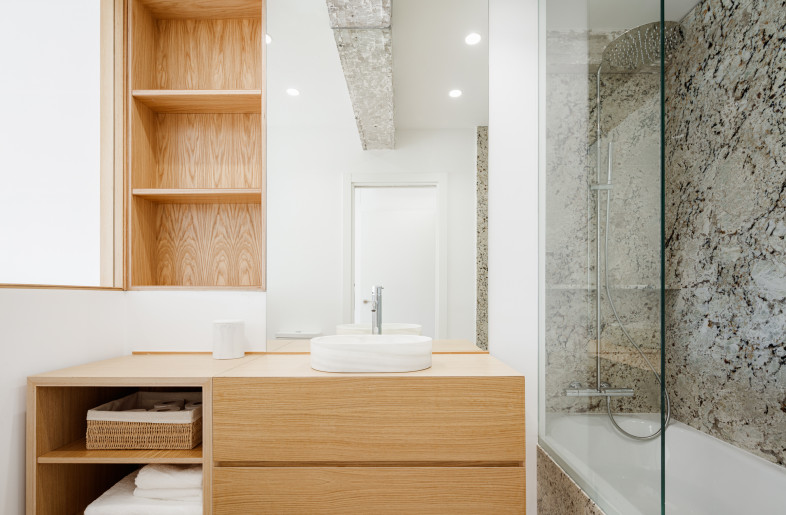 Concrete beams were left exposed throughout the space, creating contrast between the clean white walls and - Aitor Estevez