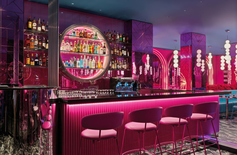 Customers are welcomed by the cocktail bar, dominated by a monolithic mirrored cylinder and a counter covered in magenta press-bent metal. - Matteo Piazza
