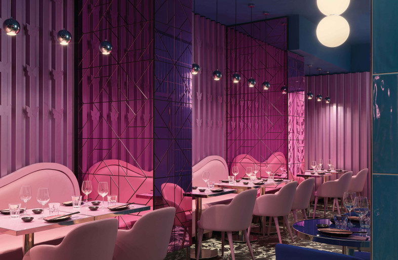 On the left side there is a more intimate area, which offers pink macro sofas, armchairs tables, which stand out against metal walls with decorative micro butterflies. - Matteo Piazza