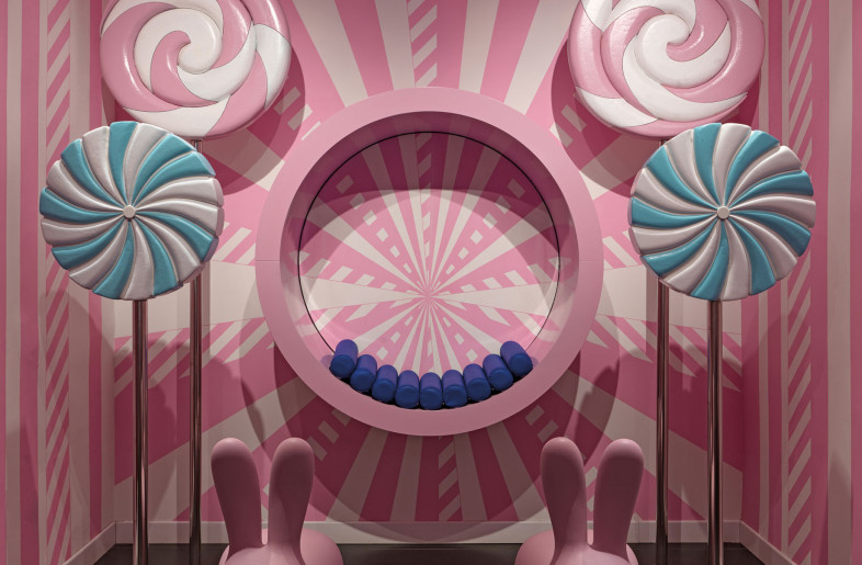 Pink and white wallpaper with dynamic geometry and macro decor elements such as butterflies, flowers, rabbits and lollipops define a pop identity - Matteo Piazza