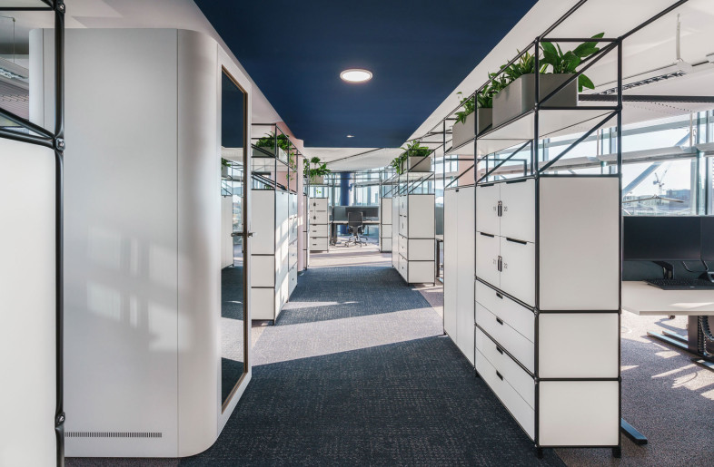 The open space office area is structured by modular shelving systems, which define the walkways without losing the open feeling of space. - Peter Margis