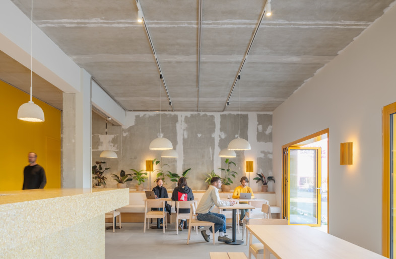 Here a welcome desk, café and co-working space are found. Its other three floors have been designated as office space. - Schnepp Renou