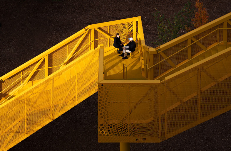 The yellow external staircase offers views over Templehof field and leads to a new porous rooftop pavilion and terrace, that can also be accessed via an internal lift. - Schnepp Renou