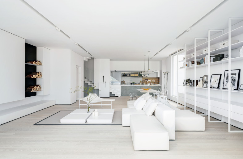 Comes to the living and dining area, designer applied only white color tone with 2 natural elements to maintain minimal quiet in the interiors, like white marble stairs and wooden flooring. - Millimeter Interior Design Limited