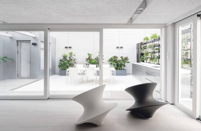 A one way sliding doors connected the family room and the garden, and it can be turned into one large functional space. As for the usual routine, the family room serve as the playground for the children. Surrounded by the other houses, the garden is lacking sunlight and view, the designer put the plant rack and arranged different plants here. Encased in greenery, the space feels peaceful yet lively. - Millimeter Interior Design Limited
