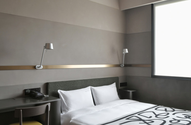 Continuing the design concept of mine, the walls create a unified but rich visual pleasure in different shades of warm grey organized in concave and convex. Stretching brass lines reach for wall lights, hooks and shelves, connecting the fixtures smoothly and rendering the grey space with a warm touch and compositional ingenuity. - Xiaodong Xu