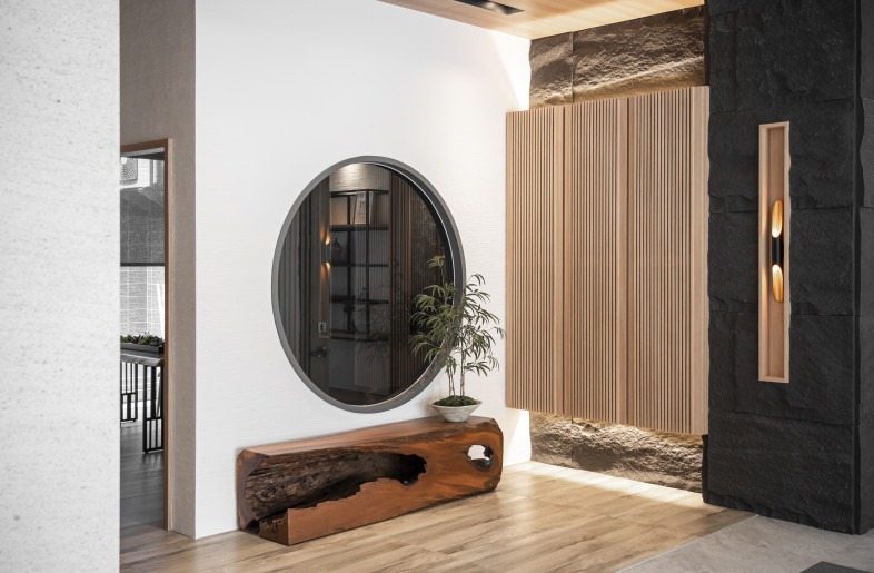 The foyer serves as the transition into the atmosphere of the house. The wooden bench is made from a piece of leftover material. - More-studio