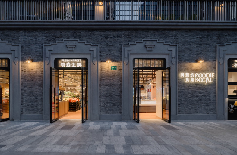 Recycled red bricks sourced from demolished houses line the entrance façade and interior walls. - Wen Studio