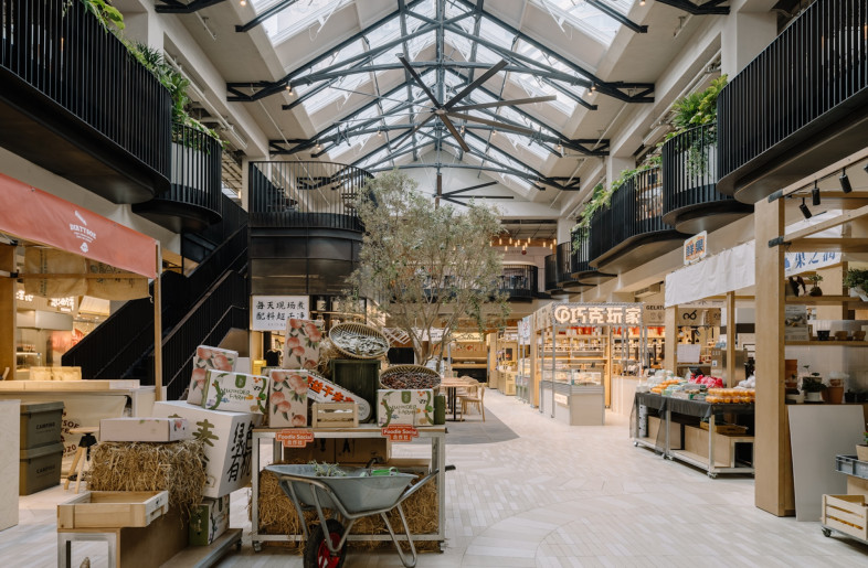 Patterned pavers extend from the street outside into the market, glass doors can be opened fully to connect the interior and exterior. - Wen Studio