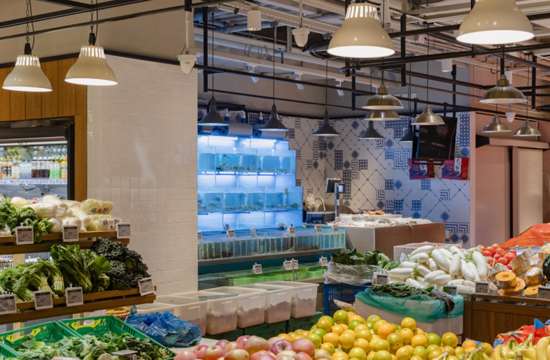 Its design is functional and is lined with a red terracotta tiled floor, timber fixtures and shelves, and a black metal rail system to hang produce, signage and lights. - Wen Studio