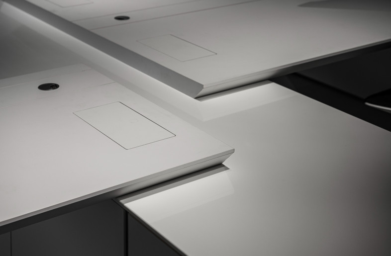 Beveled office tables meet the needs for ergonomic seating; computer cables are thoughtfully designed to storage and ventilate, making a clutter-free desktop. - AR HER KUO PHOTOGRAPHY STUDIO