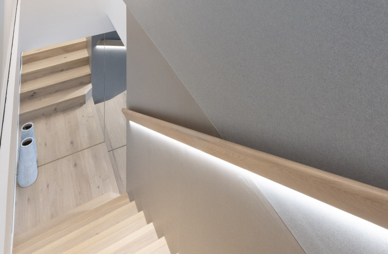 A new staircase was built to connect with the upper entity. The stairway was highlighted with a modern pendant light, a sculptural wooden banister, and floor-to-ceiling mirrors to create a bright and spacious ambiance. - Clifton Leung Design Workshop