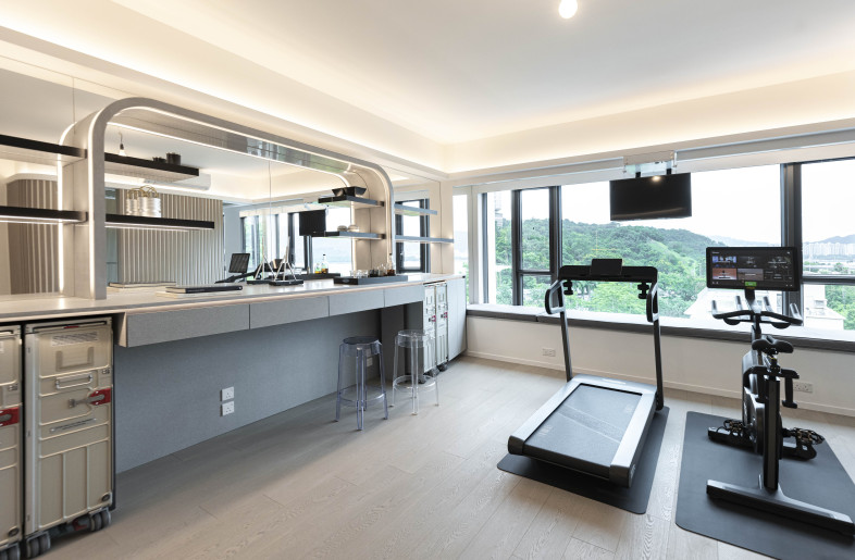 The natural fluidity of the sliding door at the multi-purpose space creates a harmonious integration of two distinct hubs.  A sense of calm continues as you transit from the home bar and gym area into the light-filled nook for yoga, providing flexibility to close off one space for privacy. - Clifton Leung Design Workshop