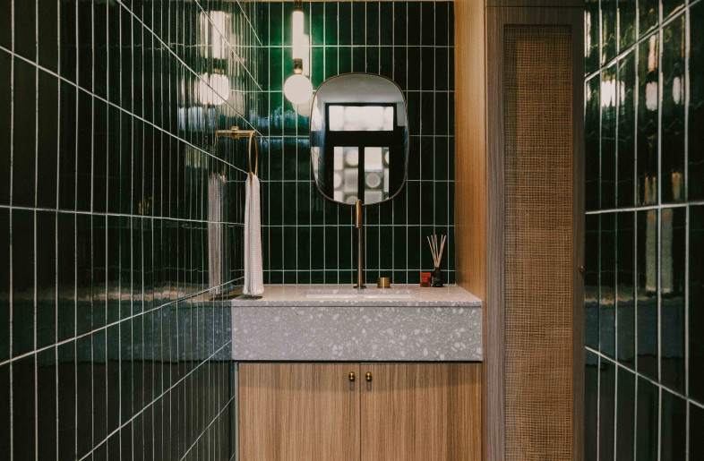 Guest bathroom continues the natural material language, with a splash of playful color - Common Studio