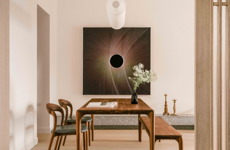 A minimal dining room with refined wood dining set and a contemporary  Japanese-inspired paper lamp from Santa & Cole. - Common Studio