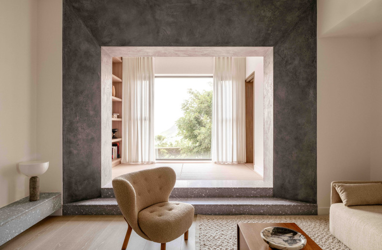 The living room's statement portal and the terrazzo steps frame the window and medication area, which was strategically built on a higher level  to strength the framing  language. - Common Studio